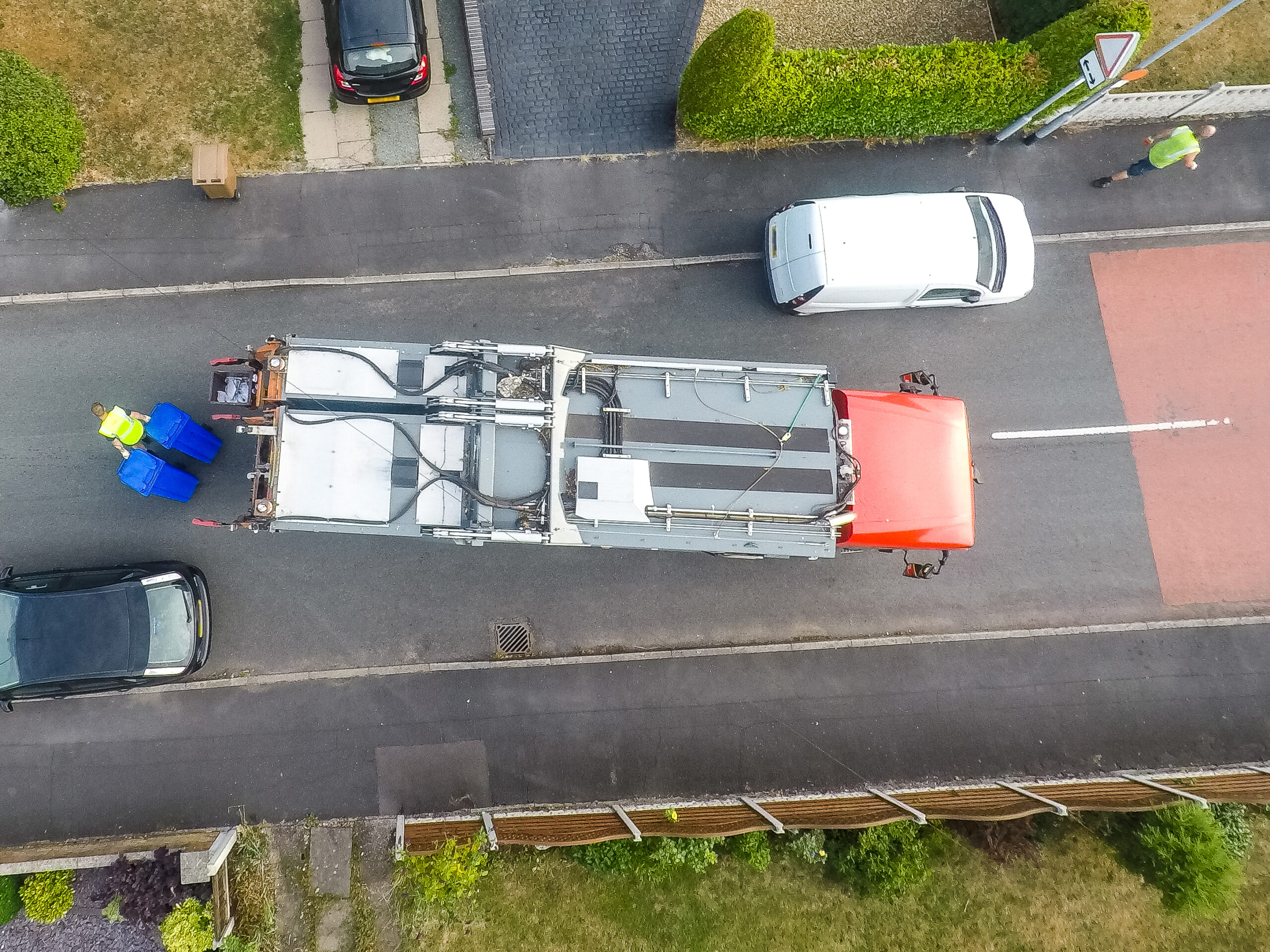 Aerial,View,Of,Dustmen,Putting,Recycling,Waste,Into,A,Waste